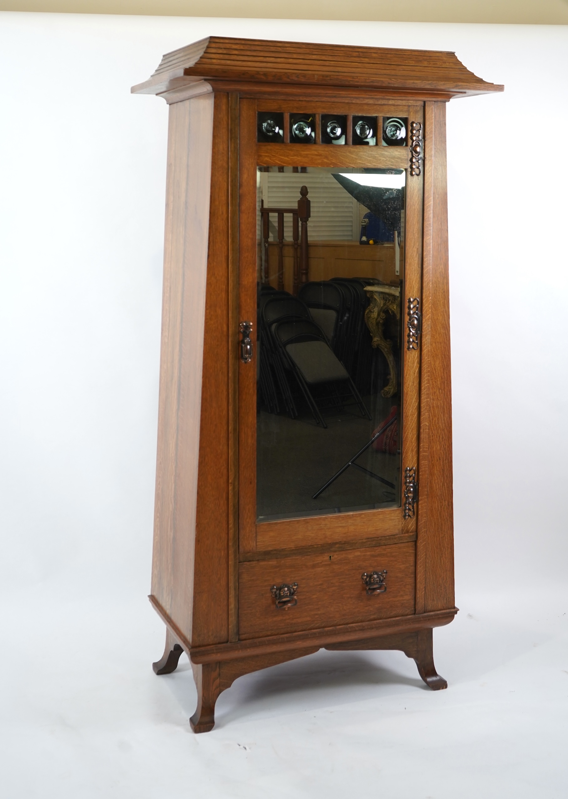 Manner of Liberty & Co: An Arts and Crafts Egyptian revival copper mounted oak wardrobe